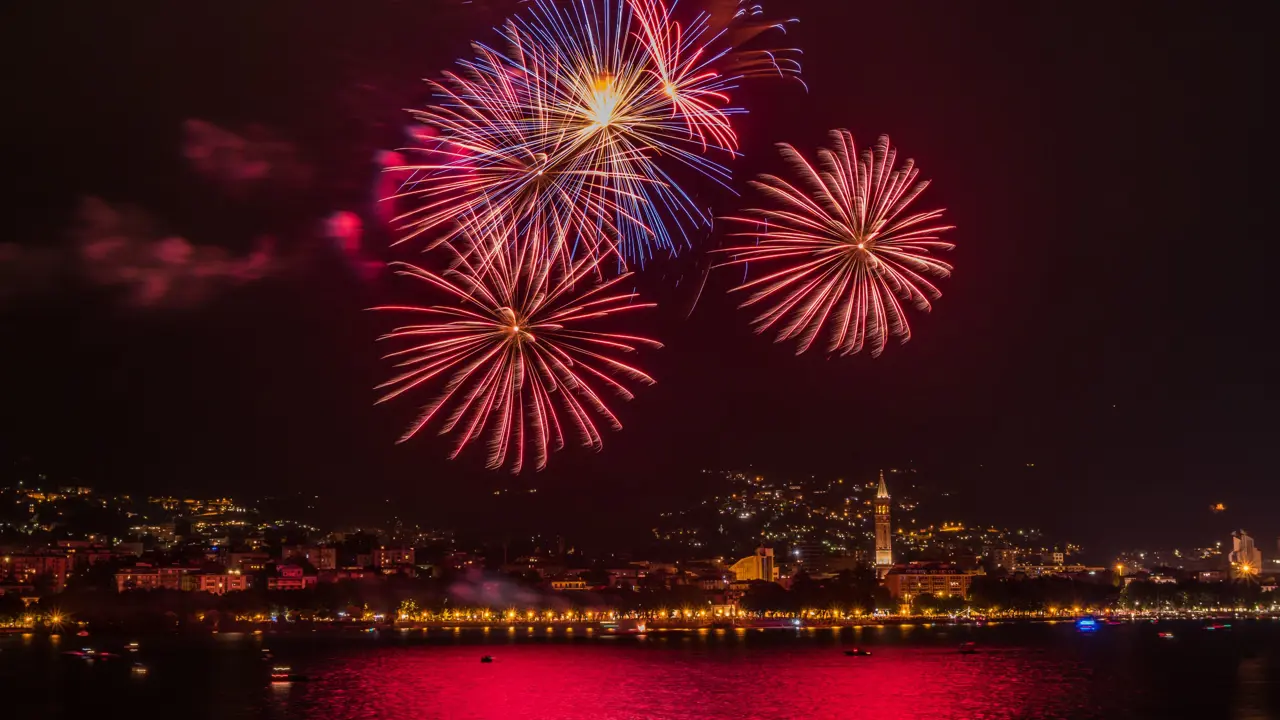 Red and blue fireworks in Lake Como on New Years Eve